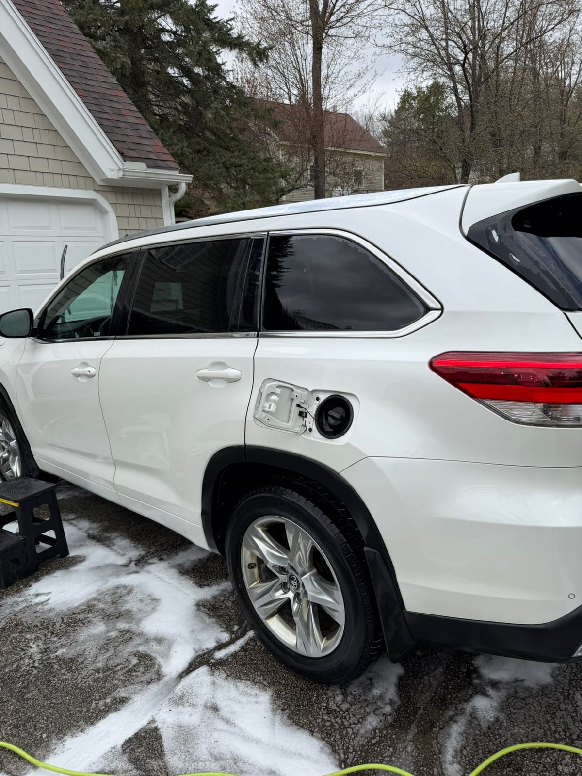 White SUV covered in foam during a mobile hand wash