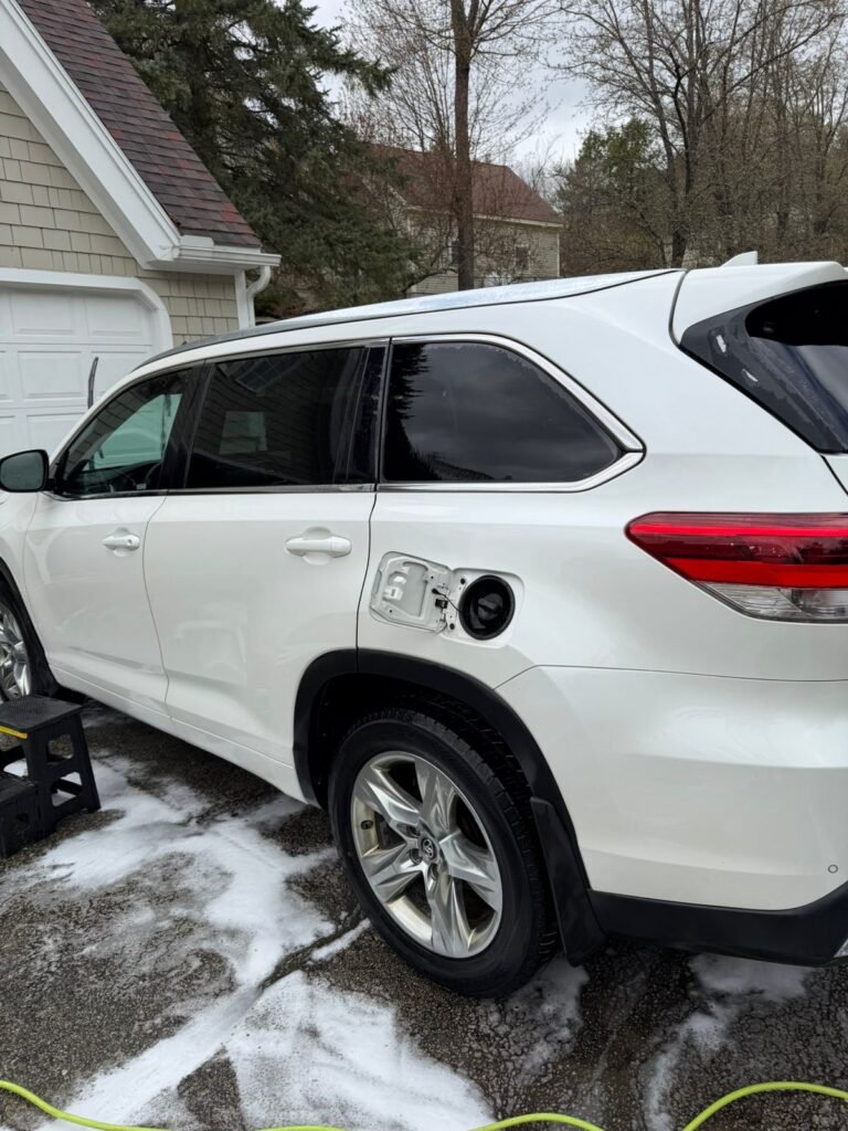 White SUV covered in foam during a mobile hand wash