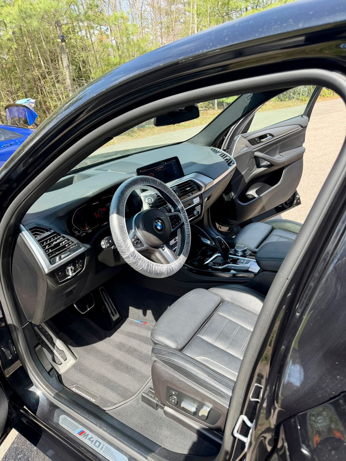 Clean front seats seen through an open car door