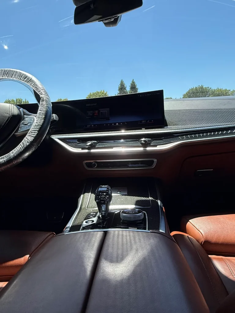 Clean BMW dashboard and brown leather seats after an interior detail