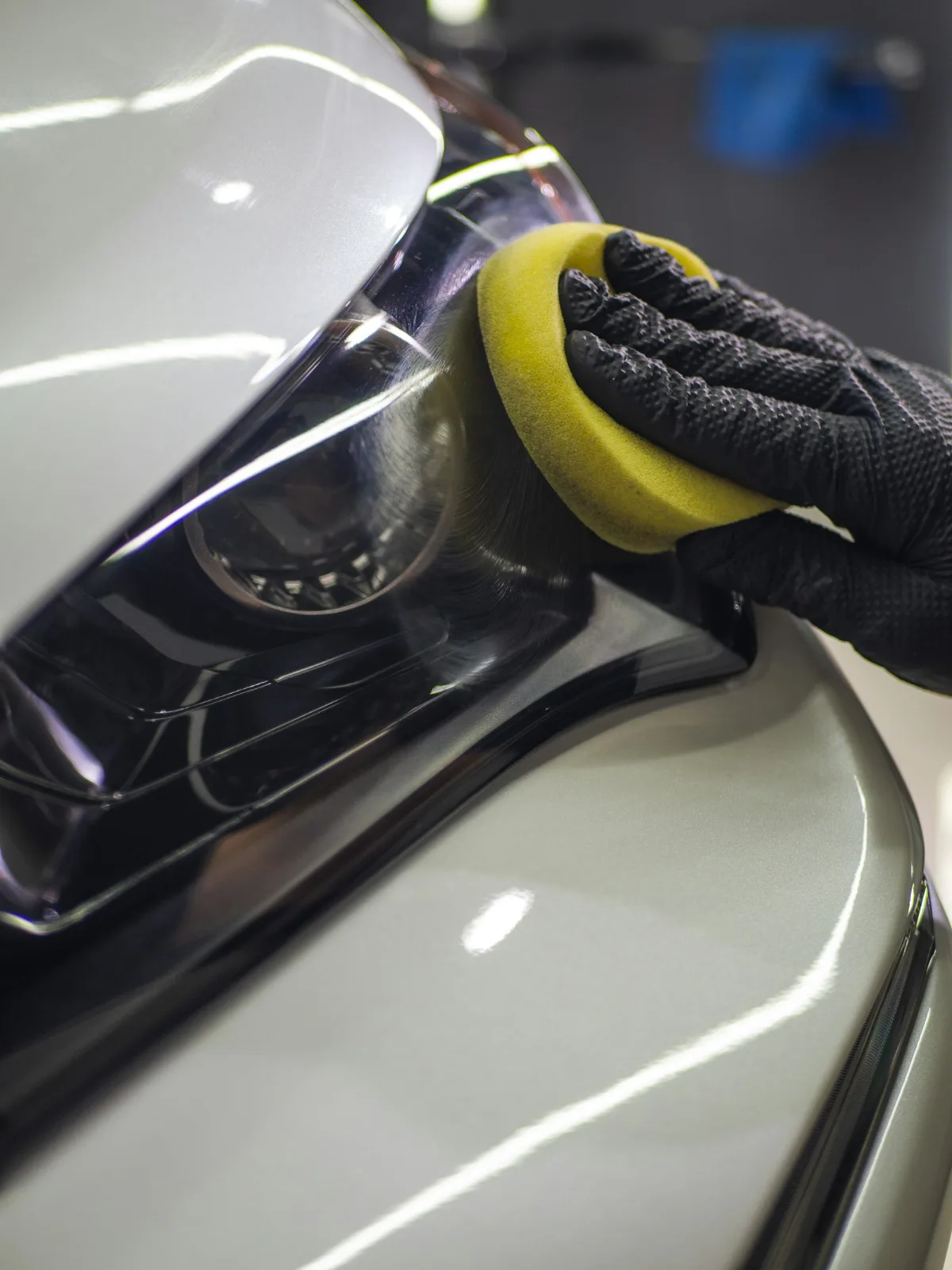 Dual-action polisher with a yellow pad polishing car paint
