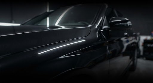Side of a glossy dark car